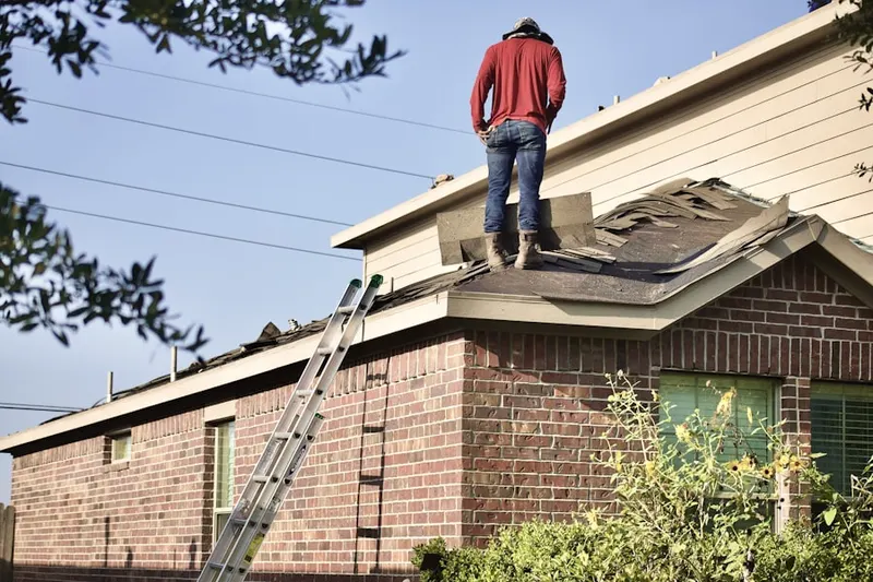 Professional roofer working on a residential roof in Grappaville
